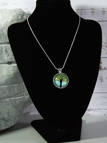 Tree of Life Cabochon with entrancing pastel greens and blues, on silver-finish snake chain necklace