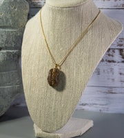 Unfinished Tiger Eye rock, dark brown with multitude of cream accents, on gold-finish snake chain