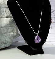 Finished and shaped Amethyst stone necklace with multitude of white and light blue accents