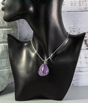 Finished and shaped Amethyst stone necklace with multitude of white and light blue accents